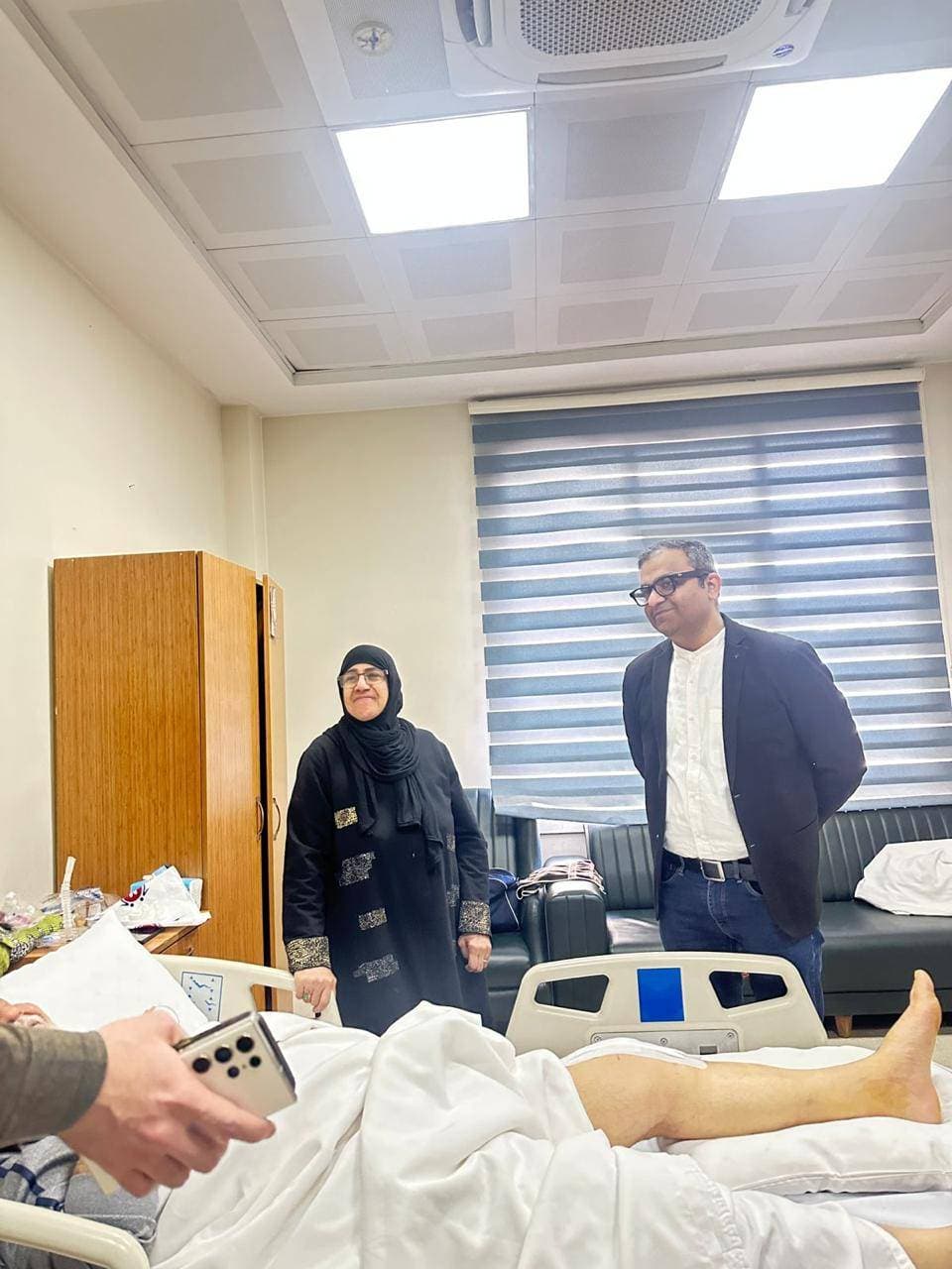 Dr. Ankur Singh visiting an international patient post-surgery during hospital rounds