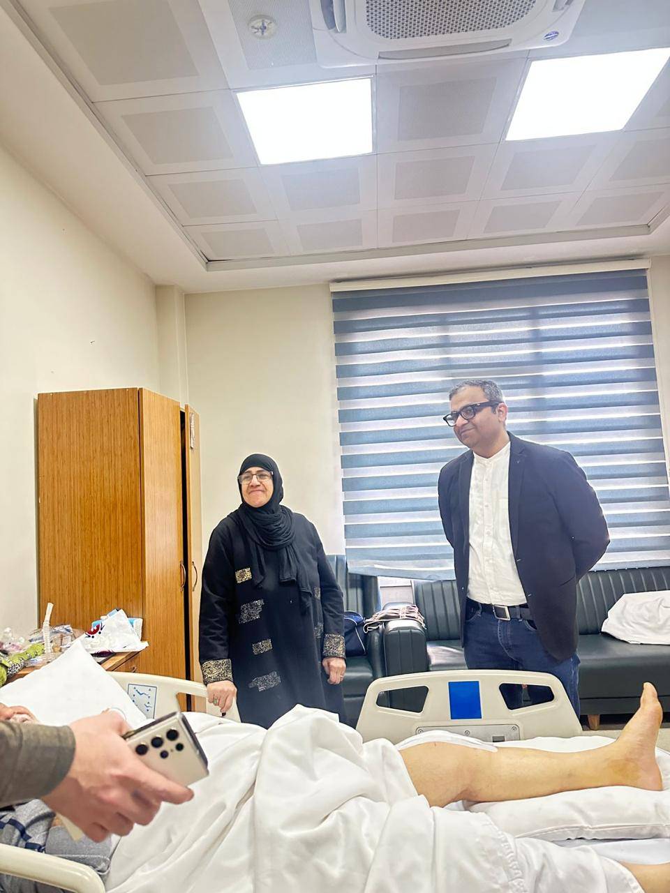 Dr. Ankur Singh visiting an international patient post-surgery during hospital rounds