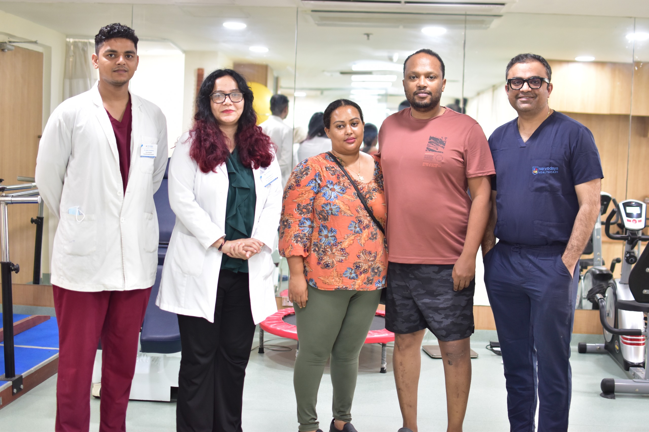 Post ACL surgery patient from Ethiopia with doctors and family at hospital